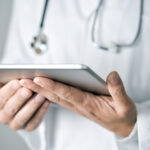 doctor man using a tablet computer