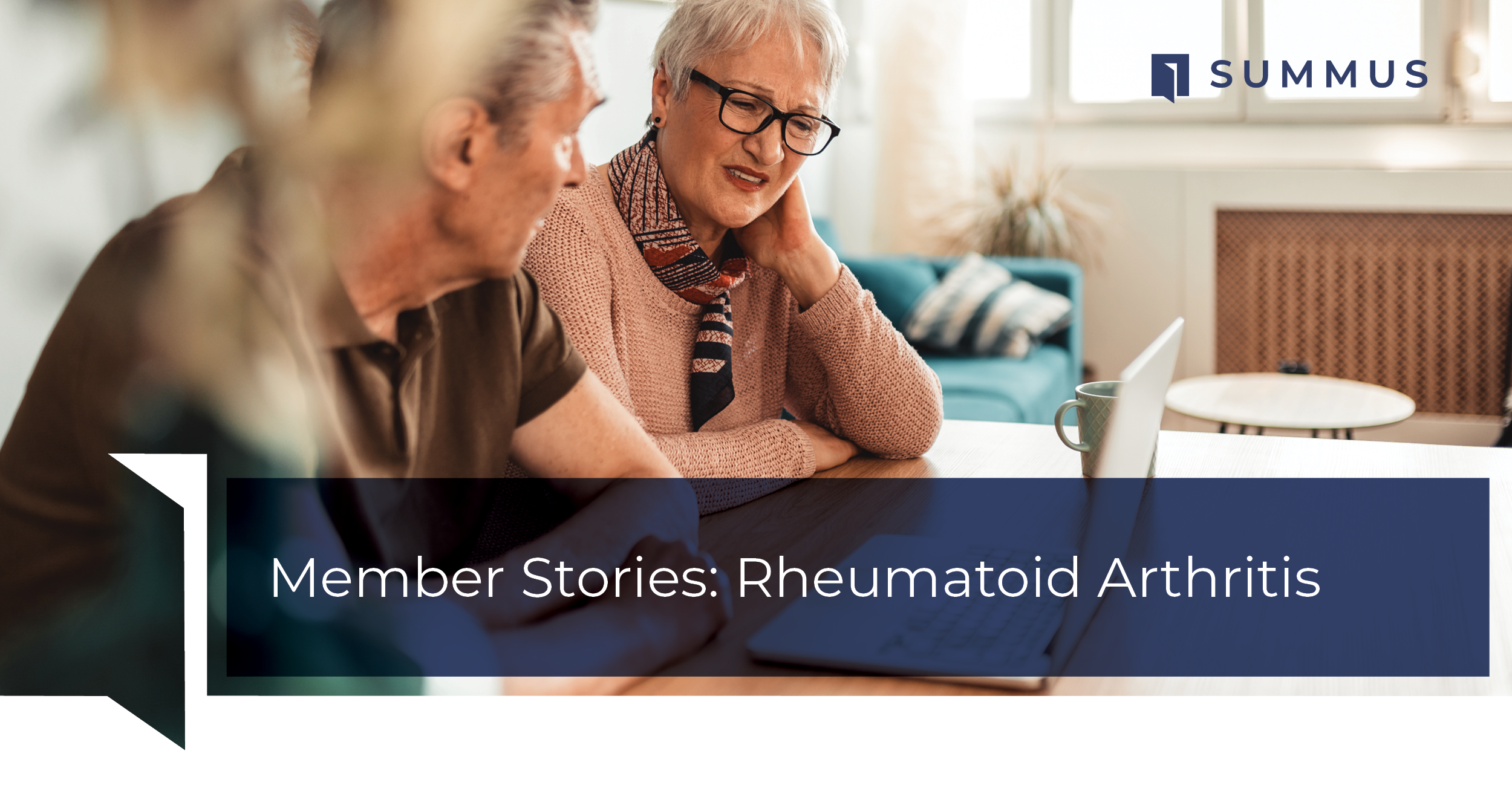 An elderly couple looking at the computer. The woman appears to be in discomfort.